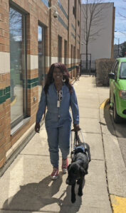 resident and her guide dog walking outside