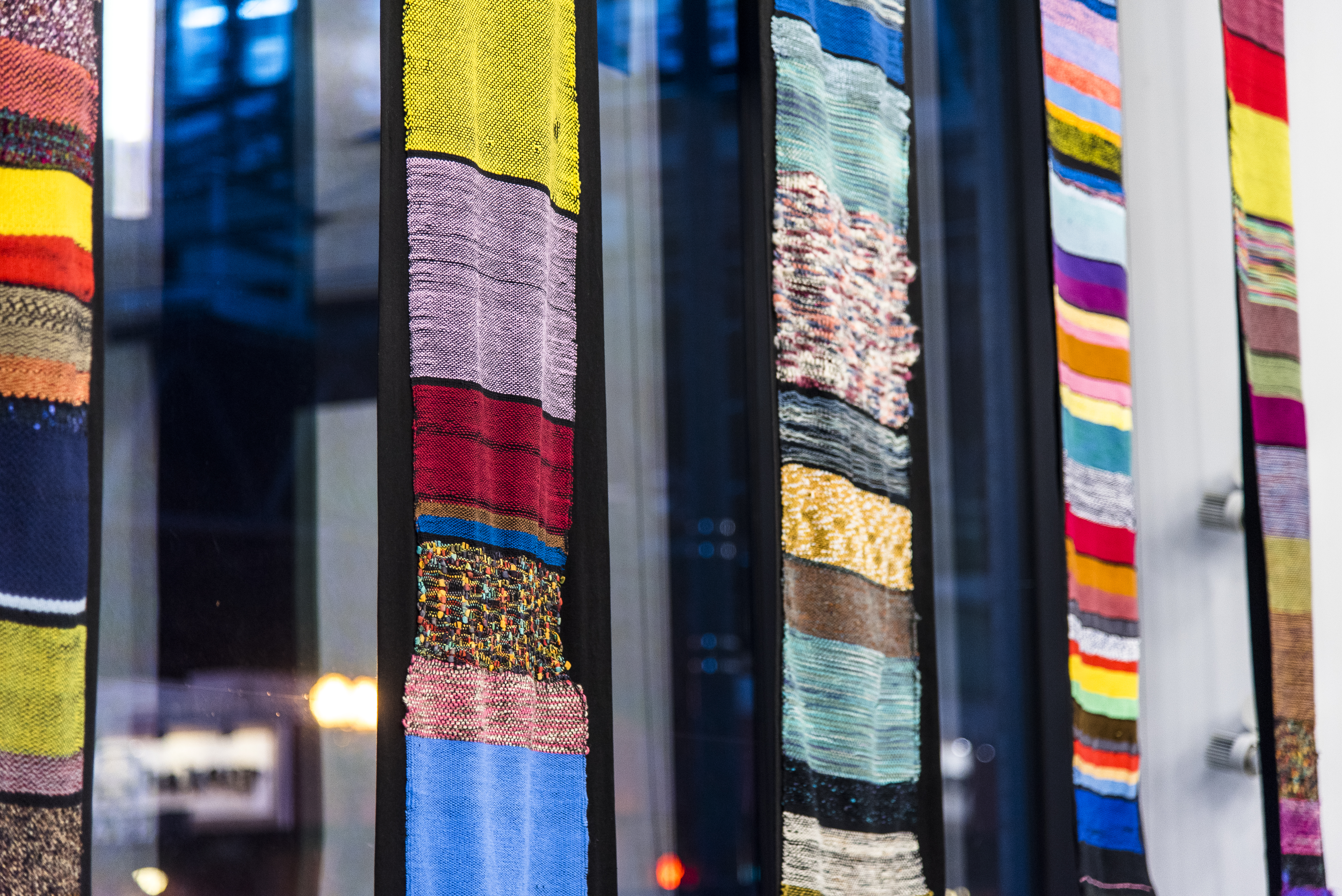 Woven Tapestries hanging in a window