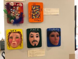 Three mixed-media pieces by Friedman Place residents. The works, cited clockwise, are "Untitled," "We Are Strong Together," and "We Face Today"